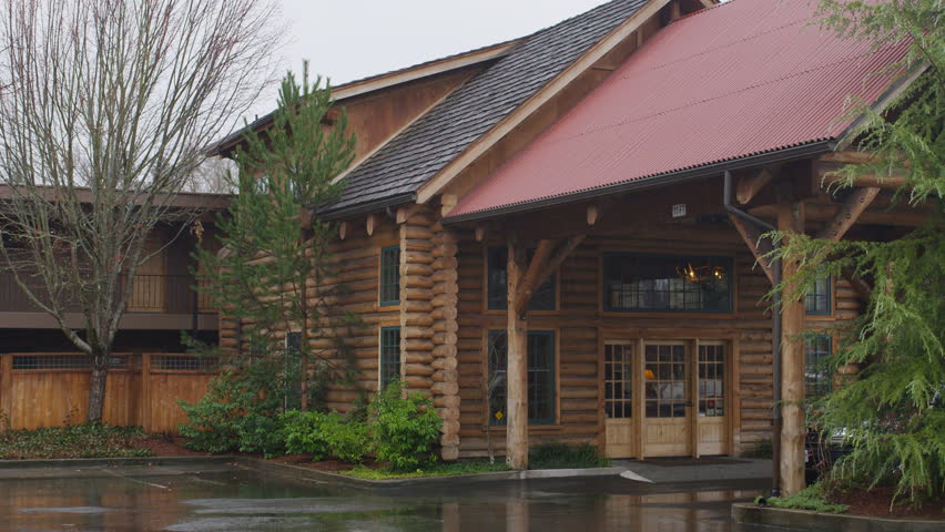 Right pan over portico of a rustic lodge in Grants Pass, Oregon