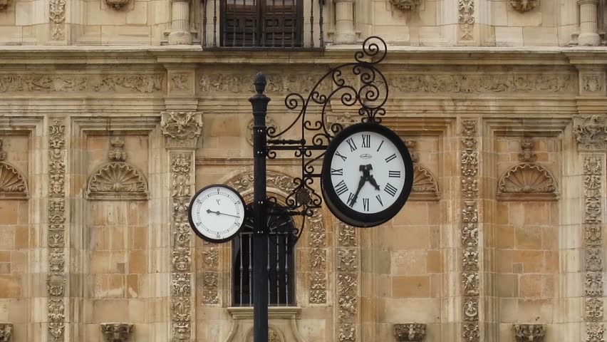 LEON, SPAIN - CIRCA MAY 2012: Time lapse of clock and people walking in front of