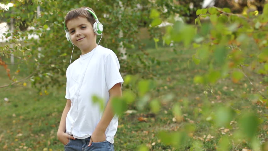 Boy listening to music outdoors