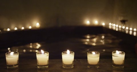 Candlelit night at jacuzzi spa pool resort in luxury private hotel room outdoor terrace. Suite for honeymoon getaway travel vacation perfect for couple relaxation. Hydrotherapy at wellness center.