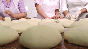 At a bakery, workers preparing bread