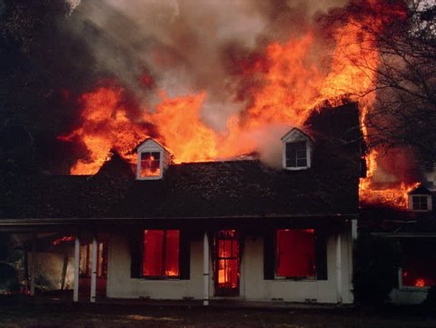 Burning house fully engulfed in flame