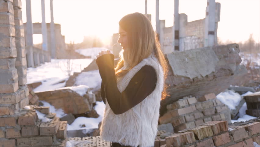 Girl in a plaid jacket on building background.