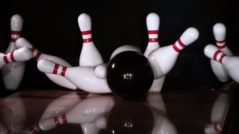 Ultra-slow motion shot of bowling ball knocking down all ten pins