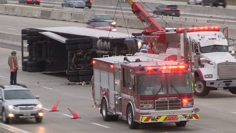Mississauga, Ontario, Canada May 2017 Tractor trailer truck accident with police and firefighters at accident scene on highway