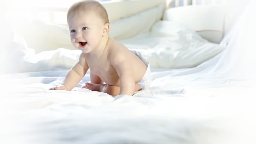 Happiness baby funning on the bed