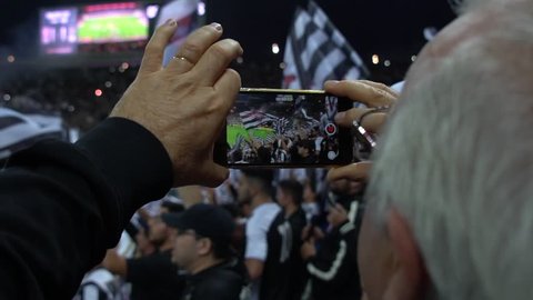 Senior Video Recording a Soccer Game in Sao Paulo, Brazil