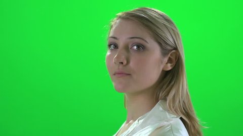 side profile face view of young attractive blond caucasian women isolated against green screen background