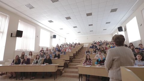 VINNITSA, UKRAINE - MAY 2017: Speaker giving presentation in lecture hall at university. Participants listening to lecture and making notes