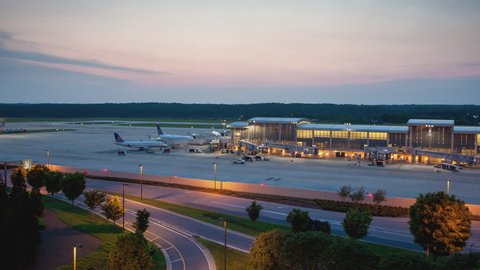 RALEIGH, NC - 2017: Raleigh-Durham International RDU Airport Platform Timelapse with Aircraft and Traffic Movement during a Colorful Sunset