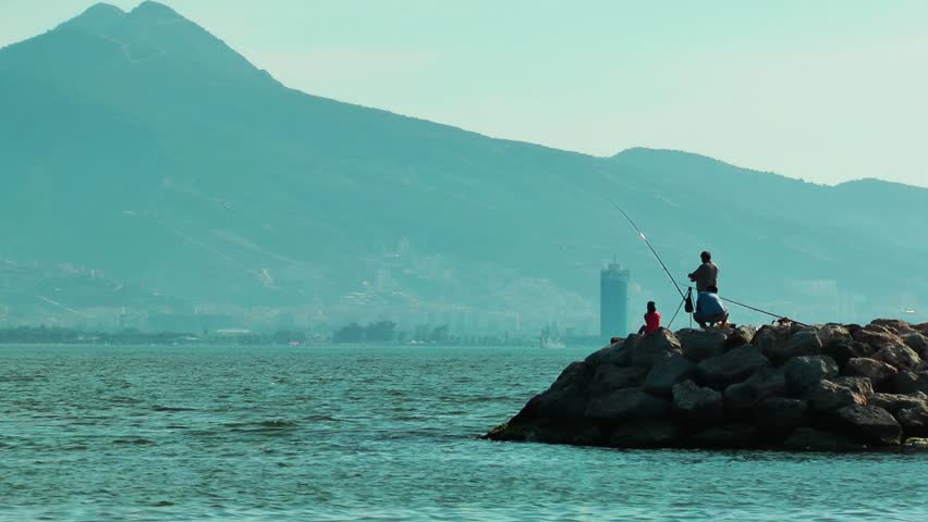 People Fishing on Rocks 