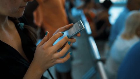 4k UltraHD Closeup of young woman hands typing sms scrolling pictures phone. Manicure. indoor teal and orange style.