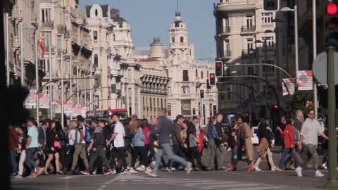 MADRID, SPAIN 01 MAY 2017: People crossing the Gran Via street to Plaza Callao in Madrid, Spain. City pedestrian traffic on a busy street in central Madrid 