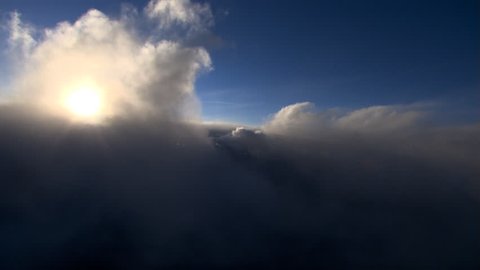 Flying through cloud plume with haloed sun