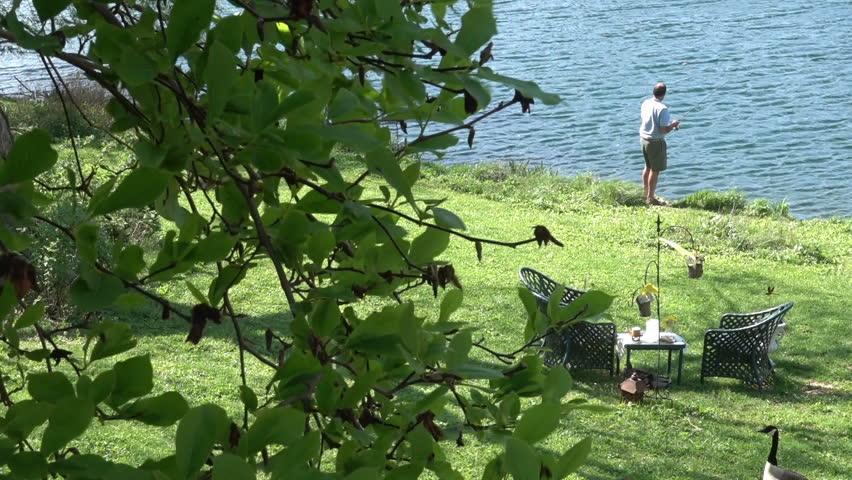 Man fishing next to lake
