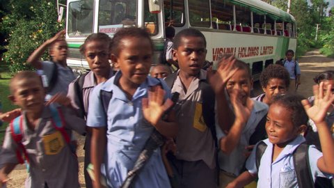 Close-up of boisterous Fijian children waving