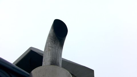 Close-up of exhaust stack of diesel truck emitting smoke and particulates