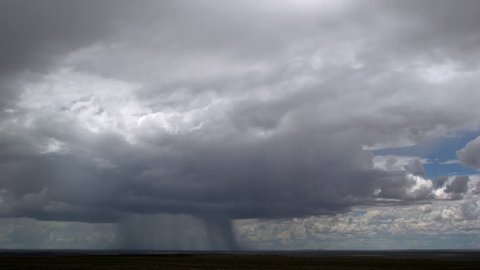 Rainstorm advancing over desert, time lapse