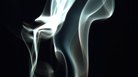 Smoke wisps drifting upward in ultra-slow motion on black frame