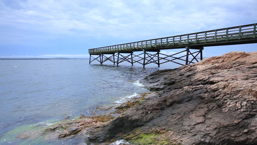A cloudy summer day at a pier in New Haven, Connecticut. Lighthouse Point Park also known as Five Mile Point