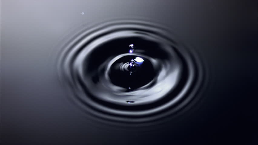 Overhead view of ultra-slow motion drop falling onto dark water and creating ring of ripples | Shutterstock HD Video #26651737