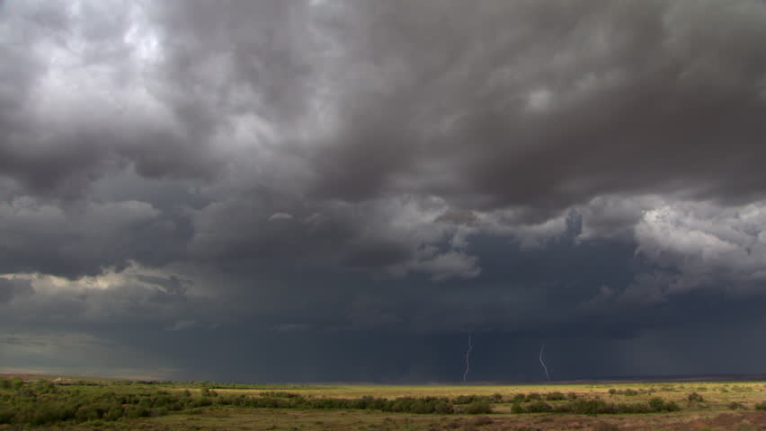 Time-lapse clouds and lightning over prairie horizon