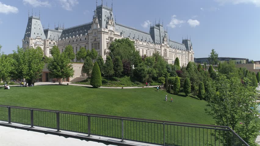 Aerial video of The Palace of Culture, Iasi, Romania on a sunny day with a green park.