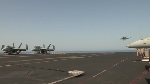 f 18 hornet landing as uss harry s truman launches and recovers aircraft