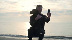 Young male take selfie with his lovely dog at the sea slow motion