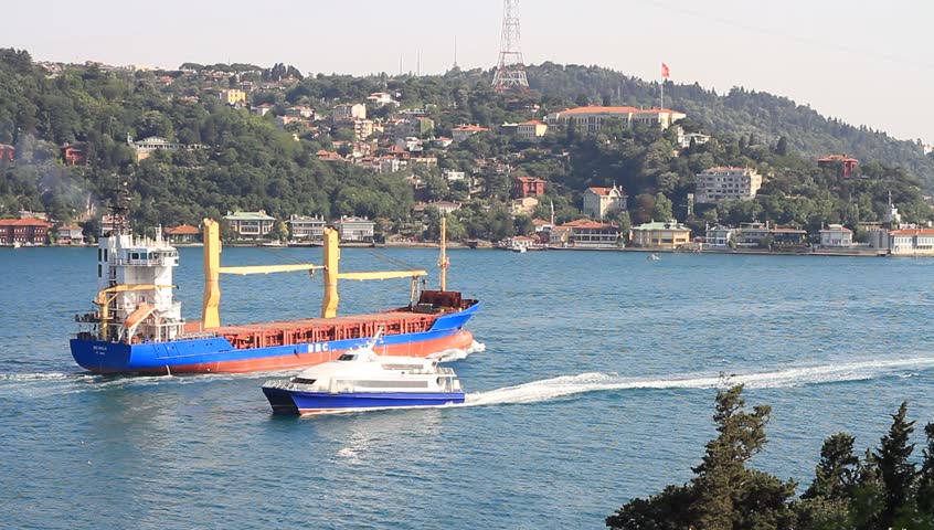ISTANBUL - JULY 5: Traffic with a cargo ship and a passenger catamaran in