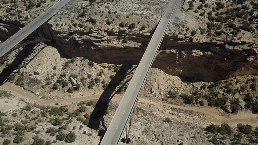 UTAH - 4 MAY 2017: Aerial Eagle Canyon Bridge transportation Utah desert overhead. Double span interstate I-70 highway deep gorge. Travel traffic overhead drone view. San Rafael Reef central Utah.