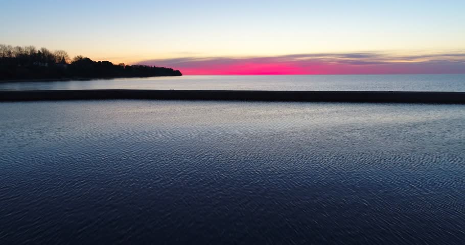 Scenic aerial flyby of Lake Michigan pier at twilight, Algoma, Wisconsin
