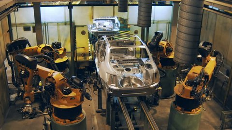 robots are welding the car body, making car body on a automobile factory
