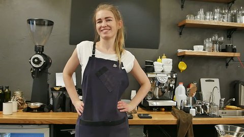 Barista dancing and laughing at work in a cafe