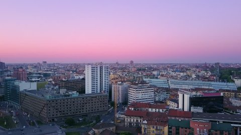 milan skyline aerial shot at sunrise flying toward city center