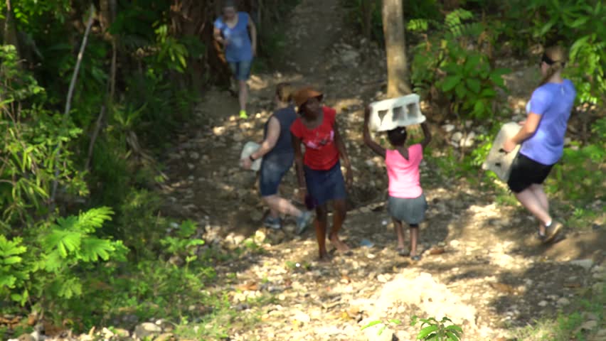 Port-au-Prince, Haiti - April 7, 2017: Women and girls carrying concrete blocks | Shutterstock HD Video #26669275