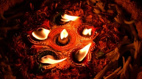 Deepabali , Deepavali or Deepawali - the festival of lights, is widely celebrated in India and now all over the world. Rangoli Diyas - colourfula and decorated candles are lit in night. 4K footage.
