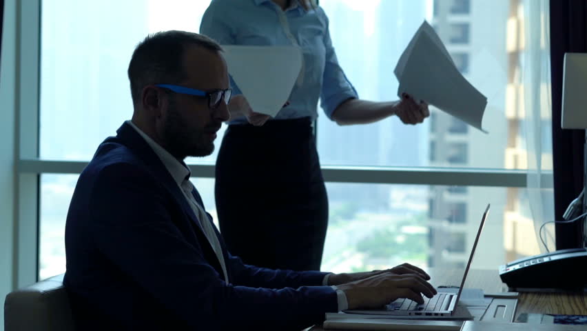 Young businesspeople with documents and laptop fighting in office 
 Royalty-Free Stock Footage #26676916