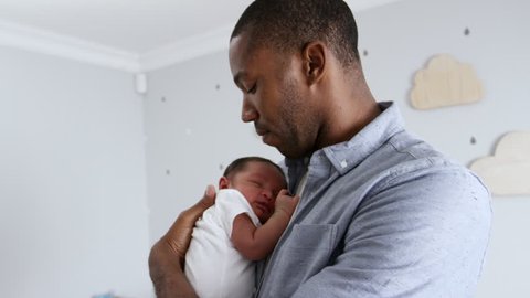 Father Cuddling Sleeping Newborn Baby Son In Nursery - Βίντεο στοκ