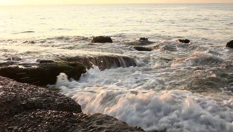 Stone in sea with wave on sunset time. nhatrang beach, vietnam.