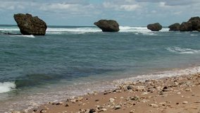 Waves crashing on the Bathsheba beach with boulders on east coast of Barbados