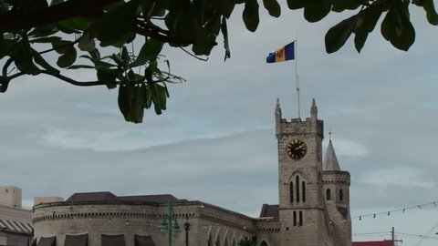Pretty shot of Parliament building with flag of Barbados flying in the wind in Bridgetown
