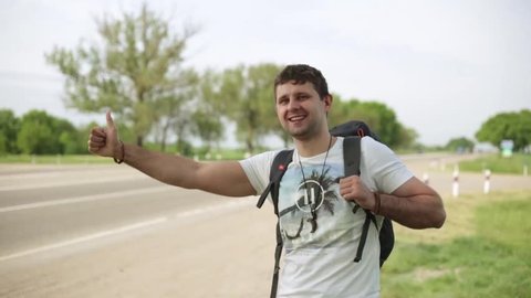 Man stops the car on road. Guy hitchhiking along a road.