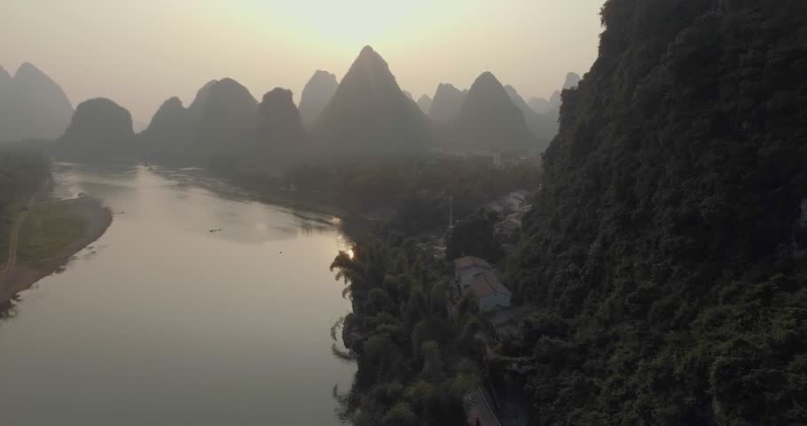 Aerial view of sunrise over karst mountain landscape in Yangshuo, Guanxi province, China. Li River and karst mountains top view. Travel, adventure and picturesque famous destination concept.