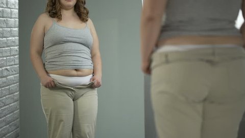 Fat girl having problems with getting into her favorite pants, overeating result