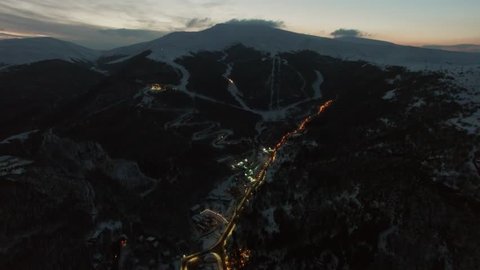 ARMENIA, CAHKADZOR - JAN 09, 2017: Ski resort and highway among mountains at winter evening. Aerial view