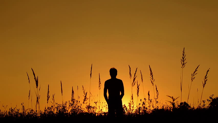 Young man training martial arts at sunset