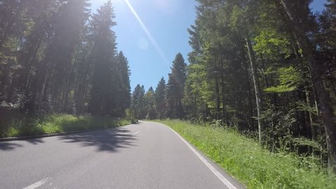 Cruising curves on mountain roads with a motorcycle resp. motorbike through summer landscape. Includes three different video sequences!