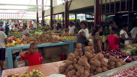 People buying produce at an open-air marketplace in Fiji