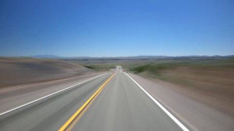 High-speed driver's POV of lonely high desert highway near Lakeview, Oregon
